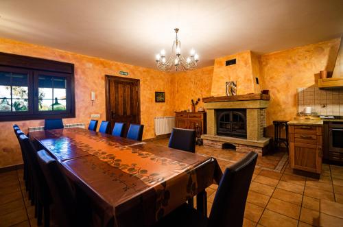 a dining room with a table and a fireplace at Casa Almoravid in Daroca de Rioja