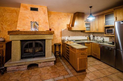 a kitchen with a fireplace in the middle of it at Casa Almoravid in Daroca de Rioja
