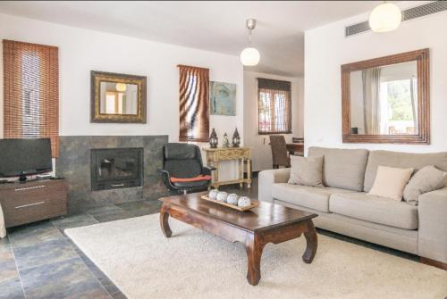 a living room with a couch and a coffee table at Casa Aguila Ibiza in Cala Vadella