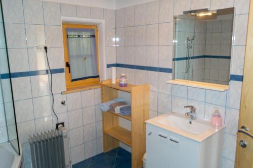 a bathroom with a sink and a toilet and a mirror at house on the top of the hill in Mozirje