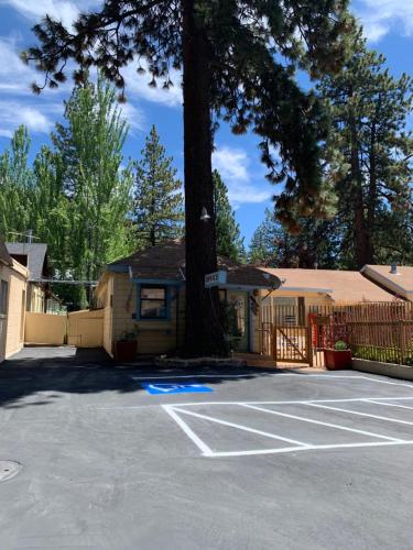 a parking lot with a tree in front of a house at Stevenson’s Inn in Kings Beach