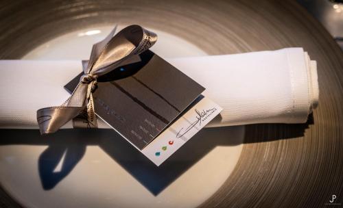 a plate with a napkin and a box on it at Hostellerie Gilain in Achêne