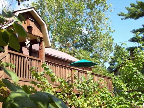 a house with a green umbrella on a deck at The Iris Garden Downtown Cottages and Suites in Nashville