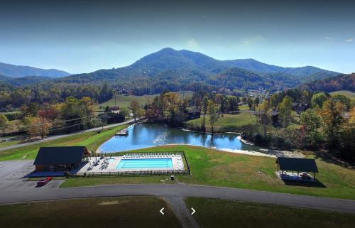 an aerial view of a river with a swimming pool at Alpine Joy-Hot Tub, Pond Access ,Cozy Cabin Retreat in the Smokies in Townsend