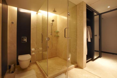 a bathroom with a glass shower with a toilet at Crowne Plaza Pune City Centre by IHG in Pune