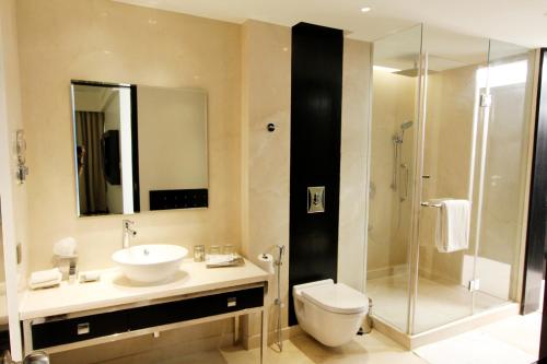 a bathroom with a sink and a toilet and a shower at Crowne Plaza Pune City Centre by IHG in Pune