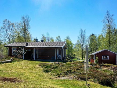 une petite maison sur une colline avec une cour dans l'établissement 4 person holiday home in F RGELANDA, à Färgelanda
