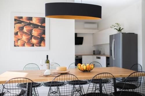 a kitchen with a wooden dining table with chairs at Villa Belveder in Pag