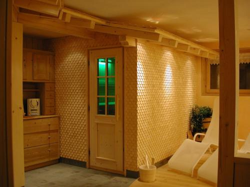 a room with a kitchen with a door and a table at Appartments Haus Monika in Schoppernau