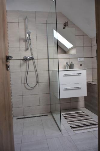 a bathroom with a shower and a sink at ADEMI Apartments in Smrečany