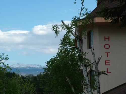 a building with a sign on the side of it at Family Hotel Emaly 1 in Bankya