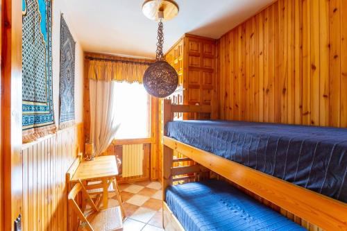 a bedroom with a blue bed and a window at Casa Dello Sciatore in Roccaraso