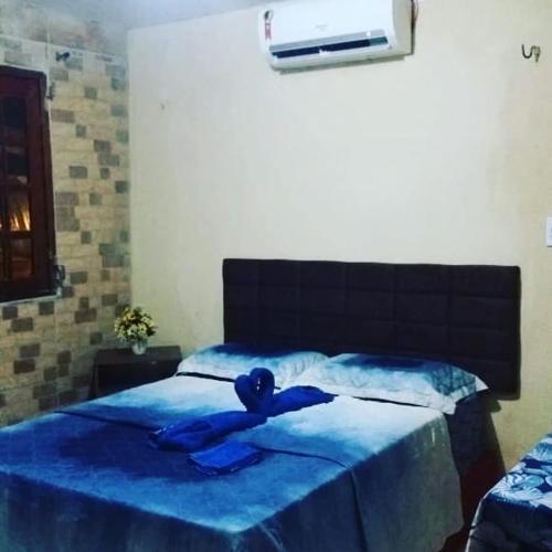 Una cama o camas en una habitación de Pousada Recanto das Fontes