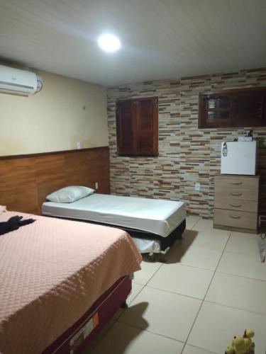 Una cama o camas en una habitación de Pousada Recanto das Fontes