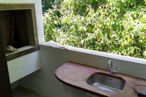 a sink in a bathroom with a window at 5. Cobertura com Vista Mar 360º Bombinhas in Bombinhas