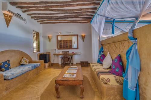 a living room with a couch and a table at SeVi Boutique Hotel in Matemwe