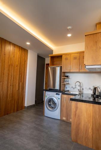 a kitchen with a washer and a washing machine at Coast House Boutique Hotel in Nha Trang
