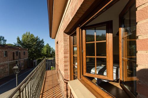 a balcony with a window on a brick building at Casa Almoravid in Daroca de Rioja
