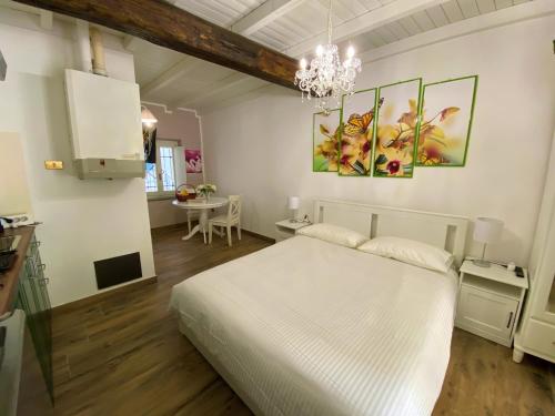 a bedroom with a white bed and a table at Nicolaus in Sesto Calende