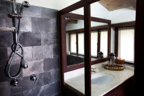 
a bathroom with a sink and a mirror at Tiger Mountain Pokhara Lodge in Pokhara
