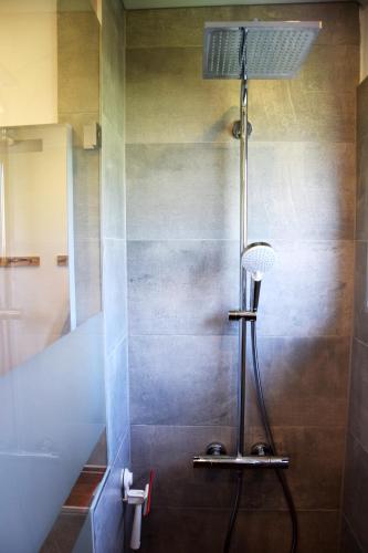a bathroom with a shower with a light on the wall at daheim im hirschen in Schönwald