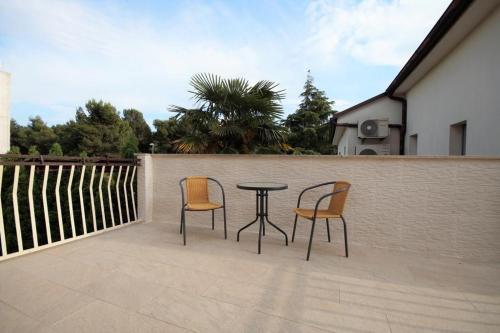 two chairs and a table on a patio at Apartment Deni in Pula