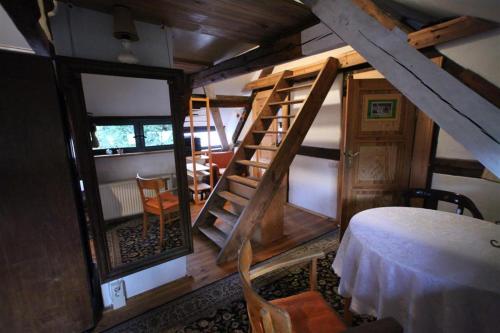um quarto com uma escada e um quarto com uma mesa em Gerberhaus Cottbus em Cottbus
