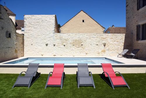 a group of chairs and a swimming pool at Le Charles V in Meursault