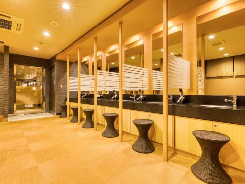 a row of stools in a public restroom at APA Hotel Hiroshima Ekimae Ohashi in Hiroshima
