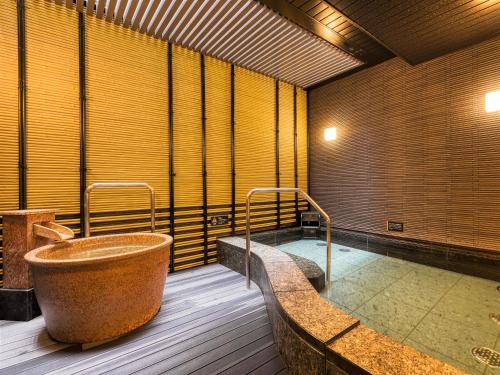 a large bathroom with a tub in the middle at APA Hotel Hiroshima Ekimae Ohashi in Hiroshima