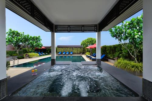 a swimming pool in the middle of a house at Centre Point Pratunam in Bangkok