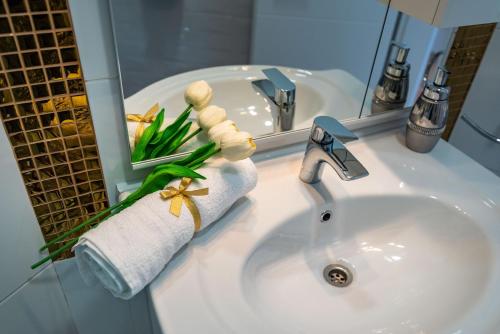 a bathroom sink with a towel and a mirror at Luxury rooms Zadar old town in Zadar