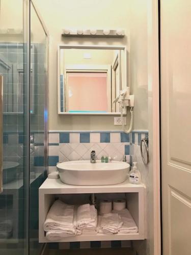 a bathroom with a sink and a glass shower at ESMERALDA'S ROOMS in Porto San Paolo