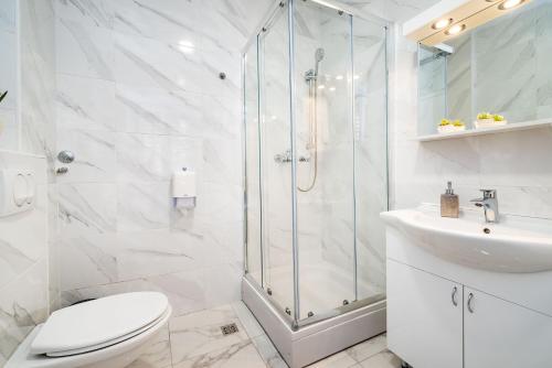 a bathroom with a shower and a toilet and a sink at Luxury rooms Zadar old town in Zadar