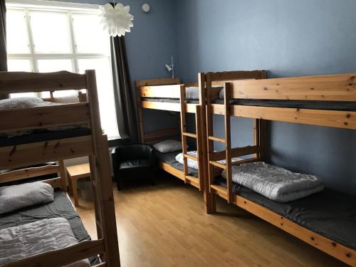 a room with three bunk beds and a window at Asa Vandrarhem in Lammhult