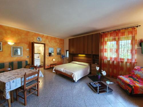 a bedroom with two beds and a couch at Casa Valenti in Brenzone sul Garda