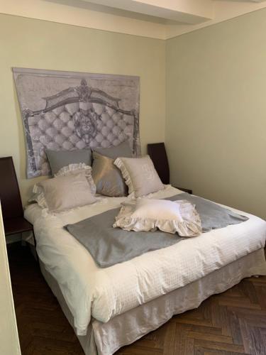a bedroom with a large bed with a large headboard at Borgoloto Suite 17 in San Marino
