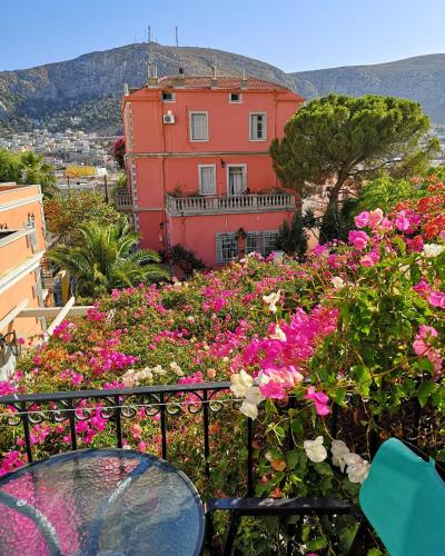 a house with pink flowers in front of it at Villa Melina Hotel in Kalymnos