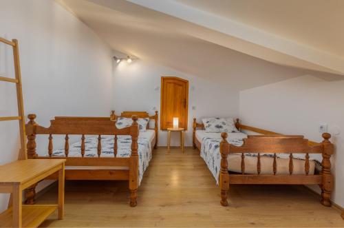a bedroom with two beds and a table at Apartments Josipovic in Fažana