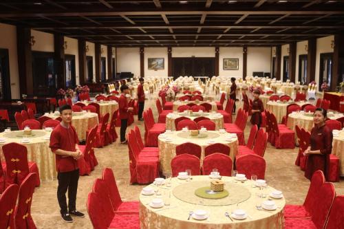 a group of people standing in a large room with tables and chairs at Khách xá Bái Đính in Ninh Binh