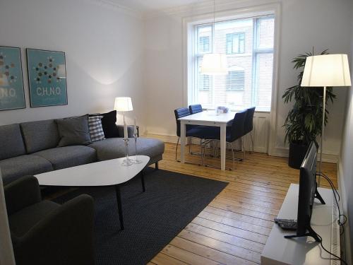 a living room with a couch and a table at Ydunsgade in Copenhagen