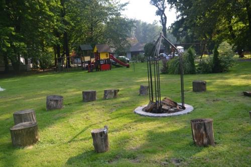 a park with a playground with a swing at Park Hotel Dobrodzień in Dobrodzień