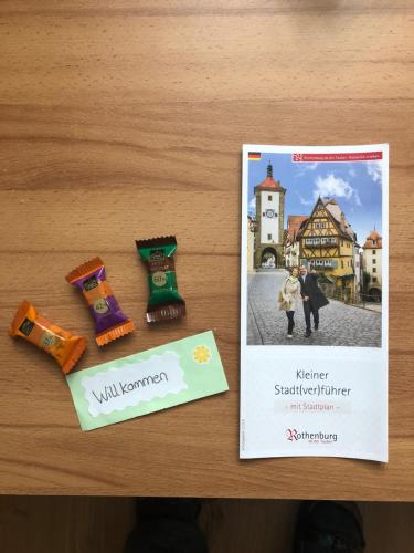 a book and three socks on a table next to a pamphlet at Ferienwohnung Winkler in Rothenburg ob der Tauber