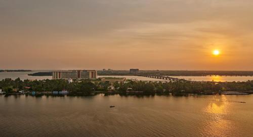 a view of a river with the sunset in the background at Grand Hyatt Kochi Bolgatty in Cochin