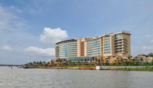 a large building next to a body of water at Grand Hyatt Kochi Bolgatty in Cochin