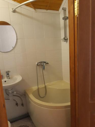 a bathroom with a tub and a toilet and a sink at Над Вичов in Volovets