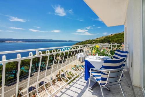 a balcony with a table and chairs and the ocean at Skalinada Sea View in Lokva Rogoznica