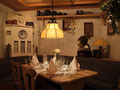 a dining room with a table with chairs and a chandelier at Hotel Restaurant Burg-Klause in Burg auf Fehmarn