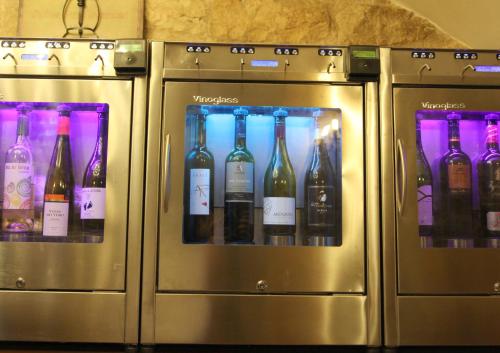 four machines with bottles of wine in them at Hotel Merindad de Olite in Olite