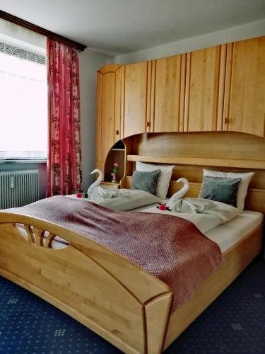 a bedroom with a large bed with a wooden headboard at Apartment Angelika in Zell am See